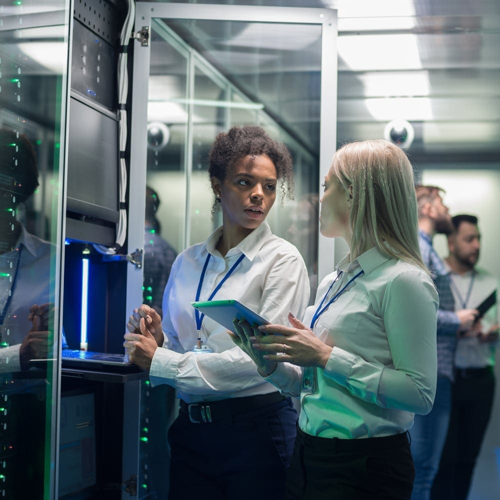 Security professionals reviewing compliance in a data center