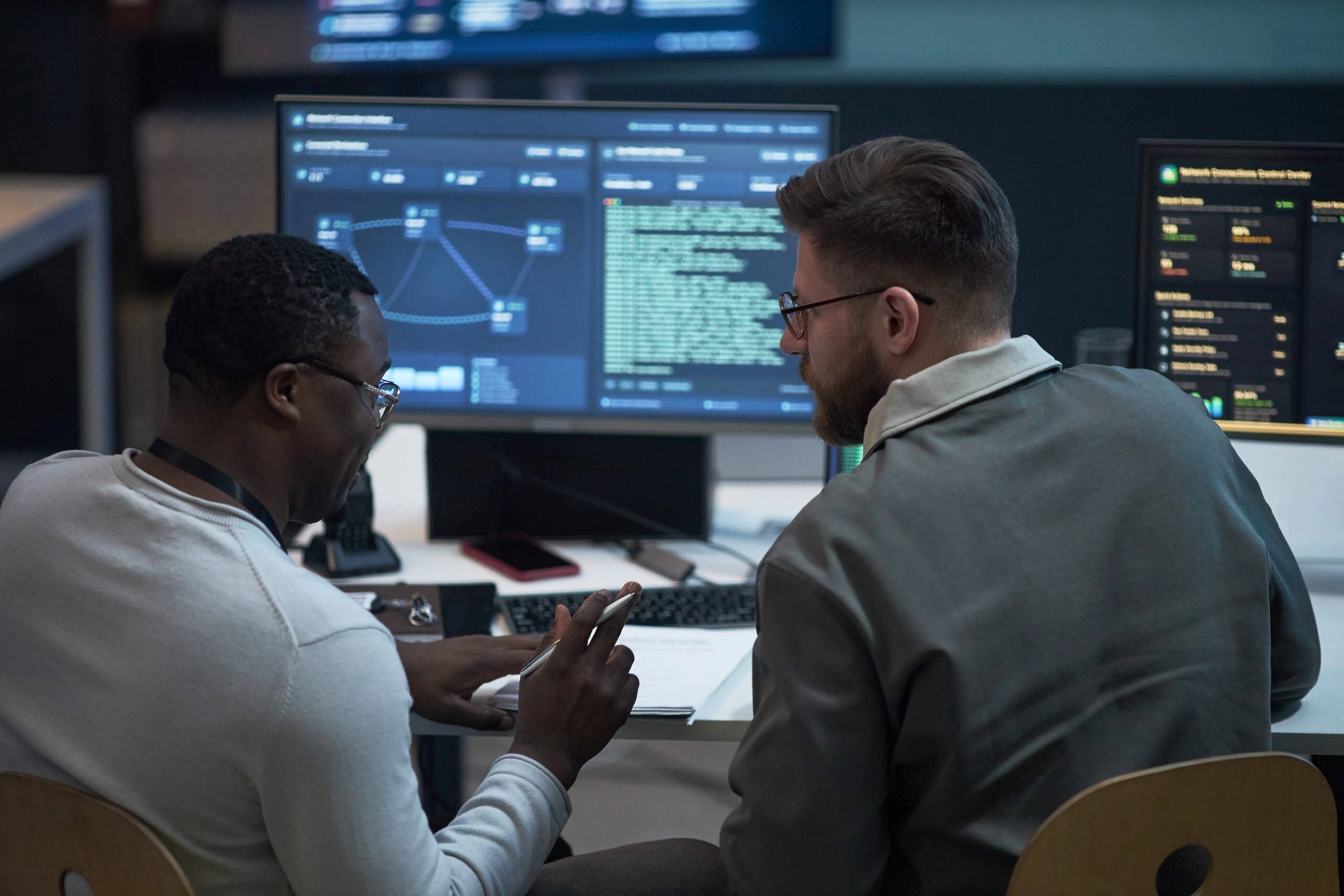 Specialists preparing for emerging threats at their workstations