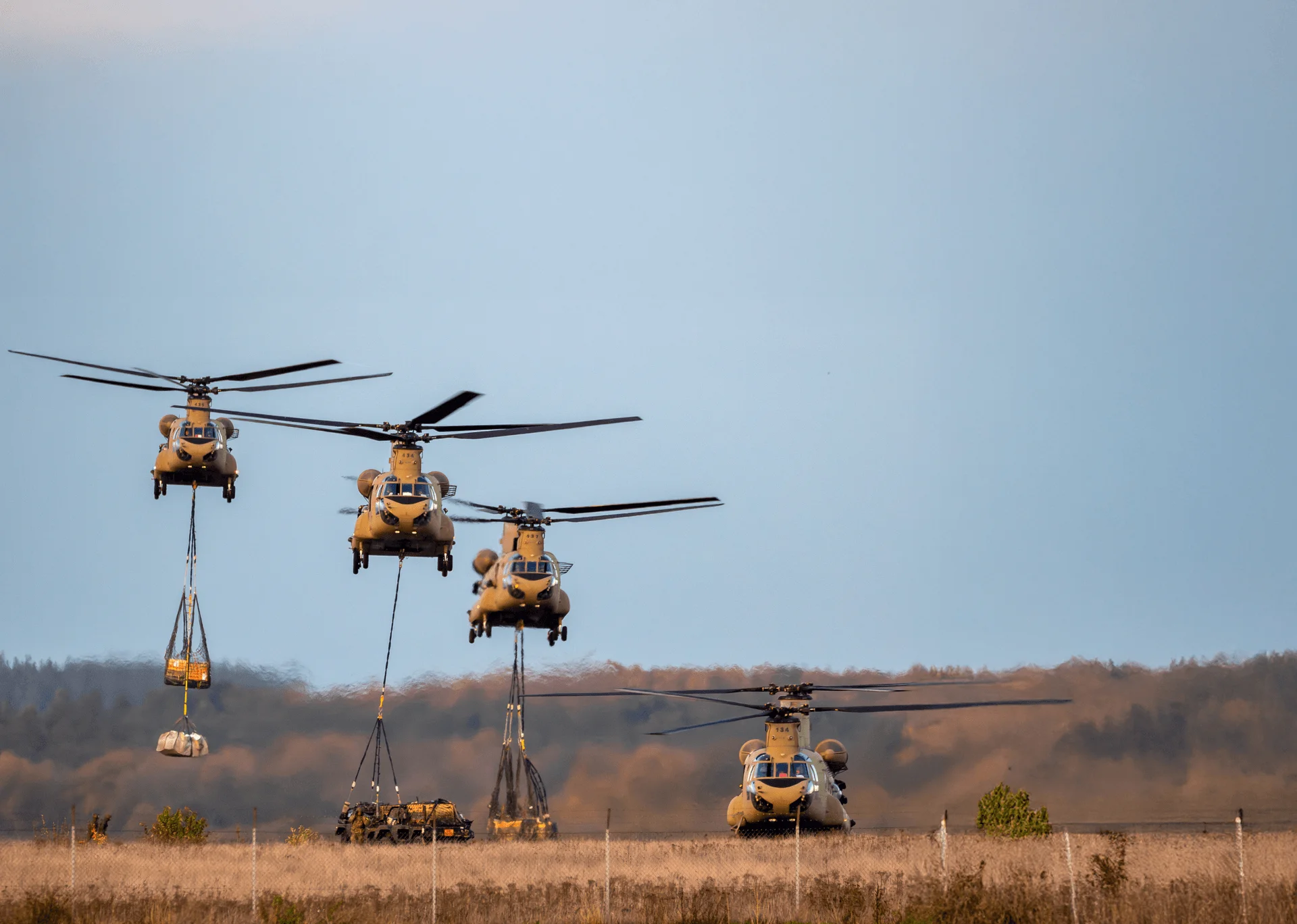 US Department of Defense helicopters carrying cargo