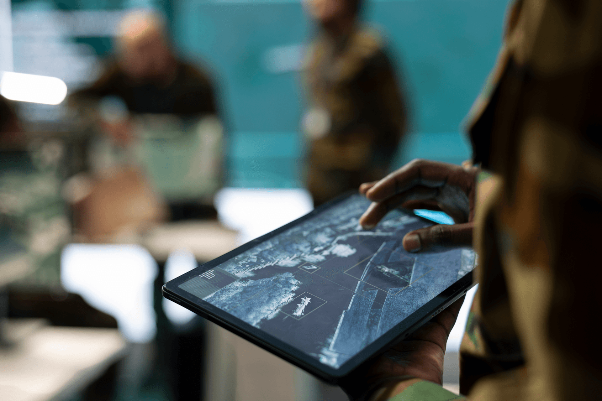 Service member reviewing tactical data on a tablet in the field