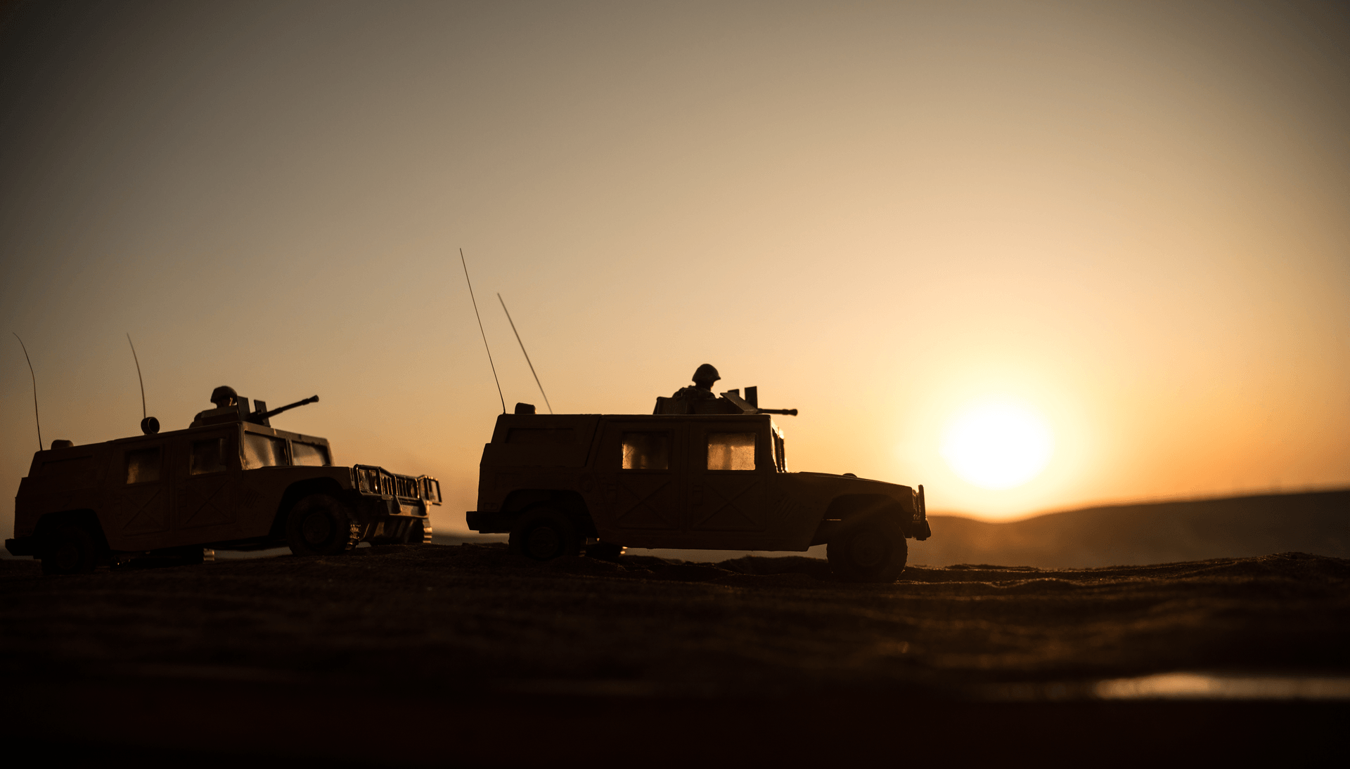 Military vehicles at sunset representing high-stakes mission operations